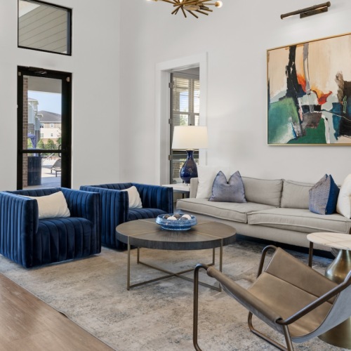a clubroom with couches, tables and chairs