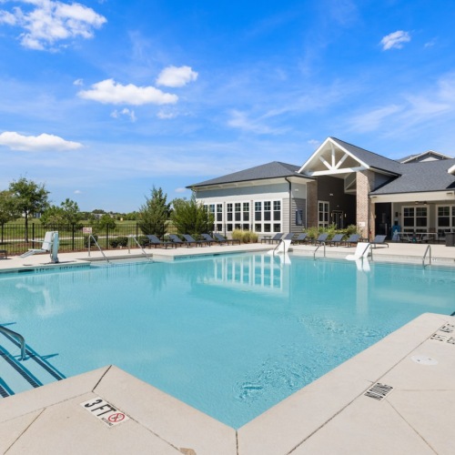 a swimming pool in front of a building