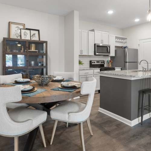 a kitchen with a dining table and chairs