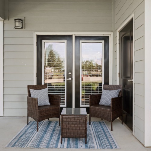 a patio with a table and chairs