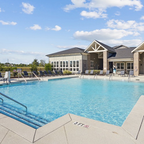 Resort-style swimming pool pool with a building behind it